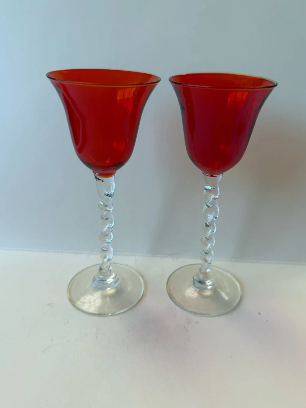 Vintage Pair of Orangy Red Apertif Glassware with Clear Twisted Stems.
